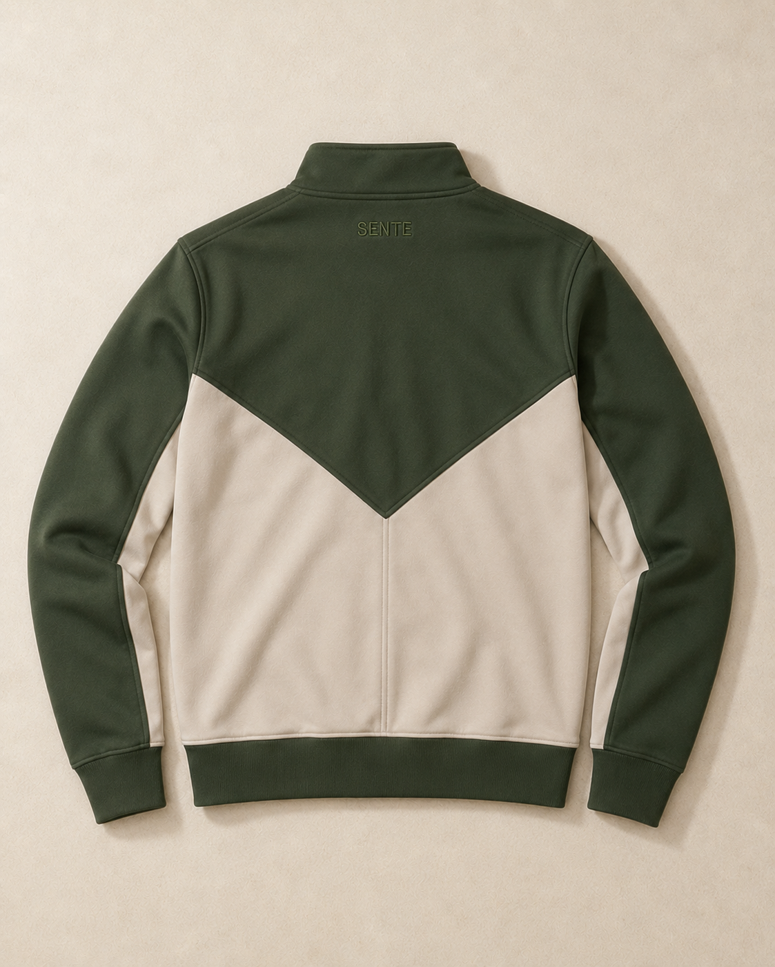 A colorblock quarter-zip sweatshirt shown from the back, featuring dark green sleeves, shoulders, and collar, and an off-white body, laid flat on a neutral beige background.
