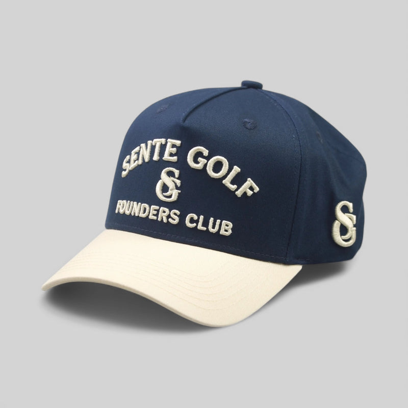 Navy blue and beige cap with 'Sente Golf & Founders Club' text on a gray background