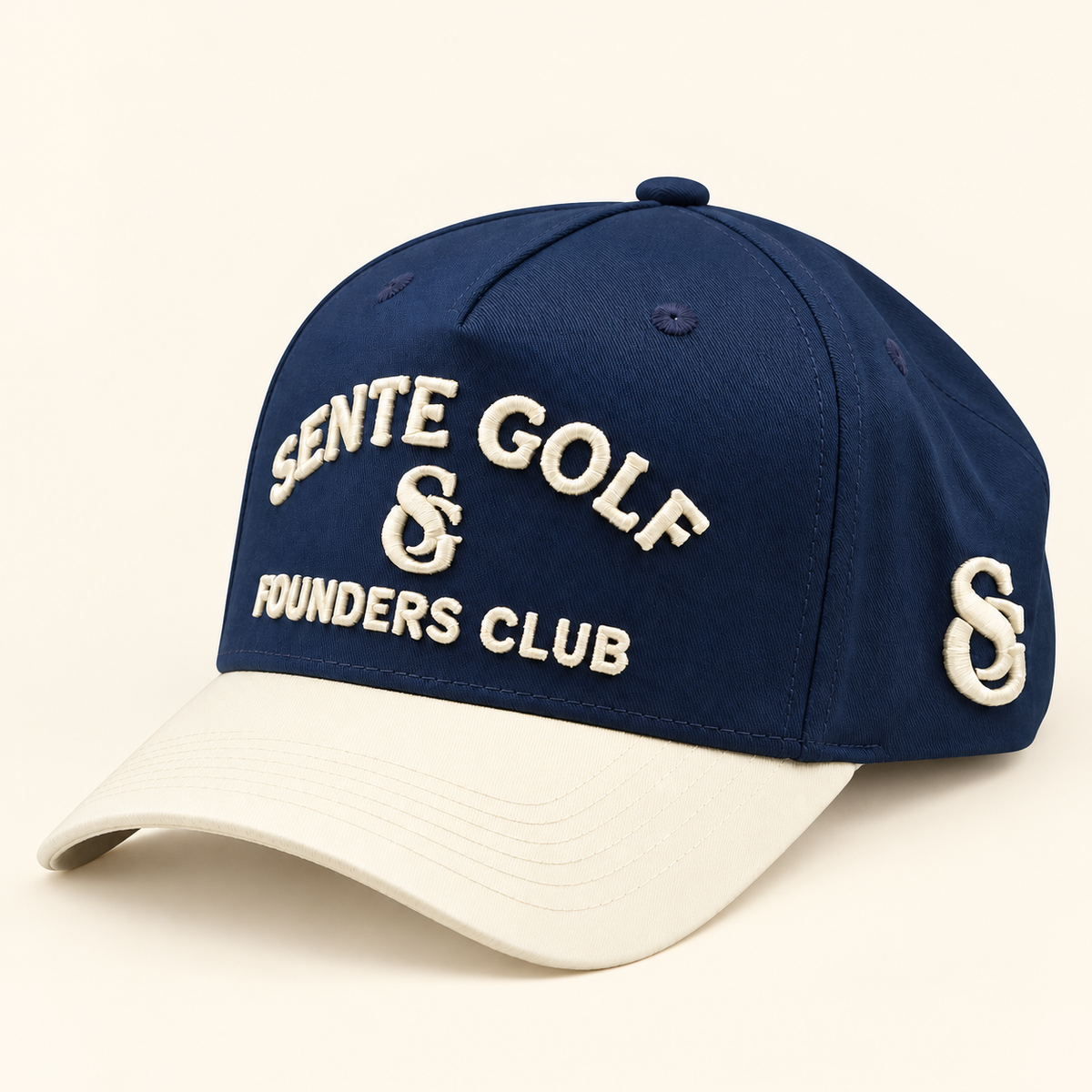 A navy blue baseball cap with a contrasting cream-colored visor, featuring embroidered white text reading 'SENTE GOLF & FOUNDERS CLUB' on the front and a matching embroidered logo on the side, set against a solid cream background.
