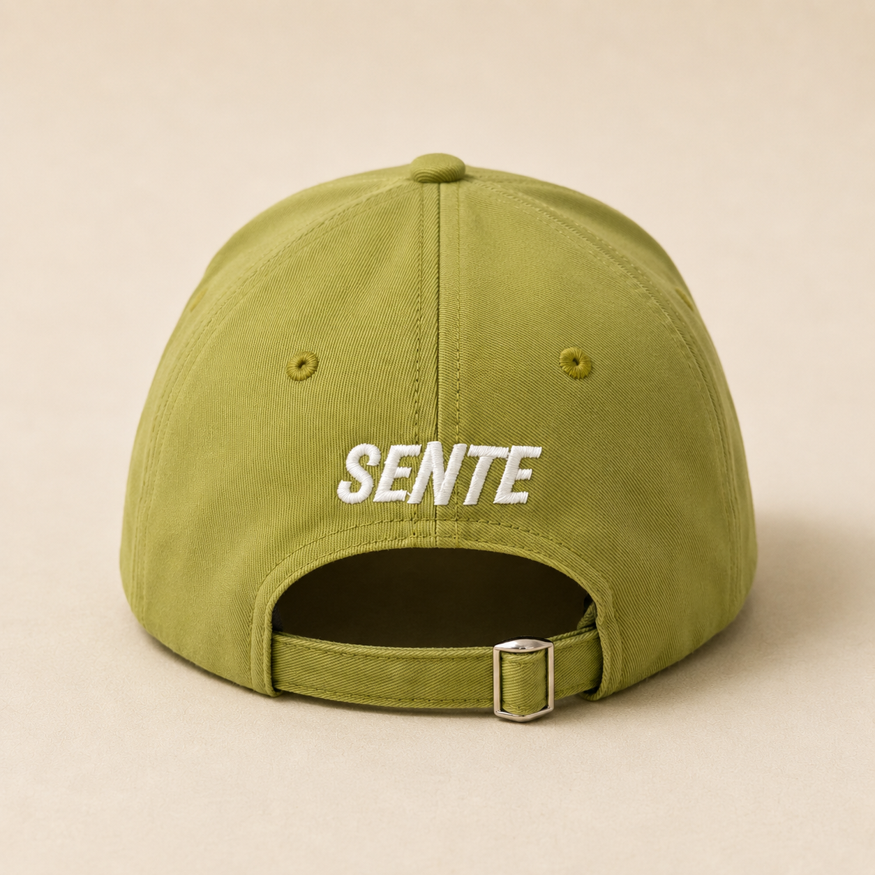 An olive green baseball cap shown from the back, featuring the word 'SENTE' embroidered in white across the center and an adjustable strap with a silver metal buckle at the bottom.