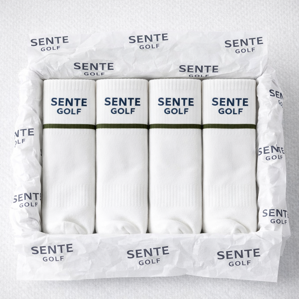 Box of SENTE GOLF white golf socks on a light gray background