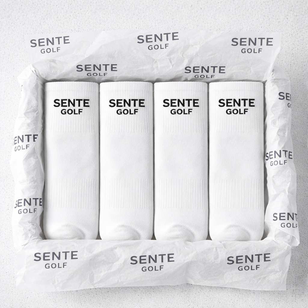 Box of white golf socks with 'Sente Golf' branding on a light gray background