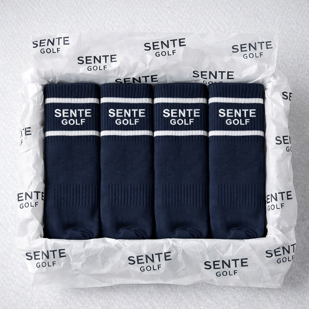 Set of four navy blue golf socks with white stripes and 'Sente Golf' branding in packaging.